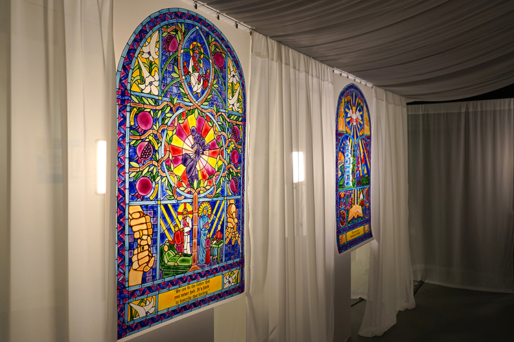 An exhibit of Middle Tennessee State University Honors student Eli Ward’s work is shown on display during the fall semester inside the Todd Art Gallery at MTSU in Murfreesboro, Tenn. By painting on translucent paper, Ward was able to replicate a stained-glass appearance with lights behind hanging white sheets, imitating windows. (Photo by Robin E. Lee)