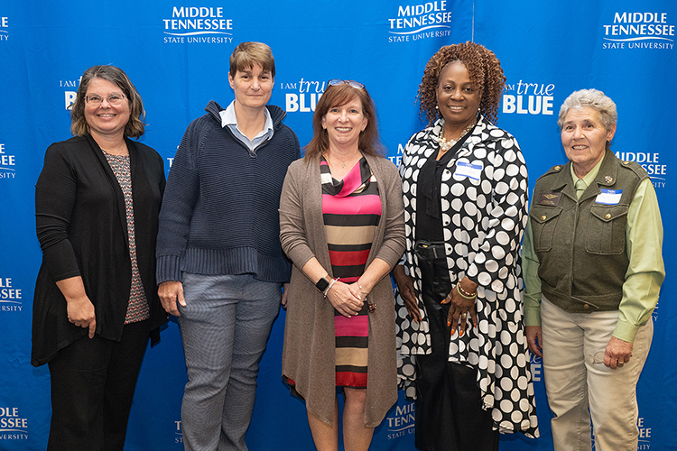 Five Women Warriors nominees standing in front of a blue background. From left to right: Dr. Joann Neubauer, Anne Anderson, DeAnne Hathaway, Twylla Peebles, and Kimberly King.