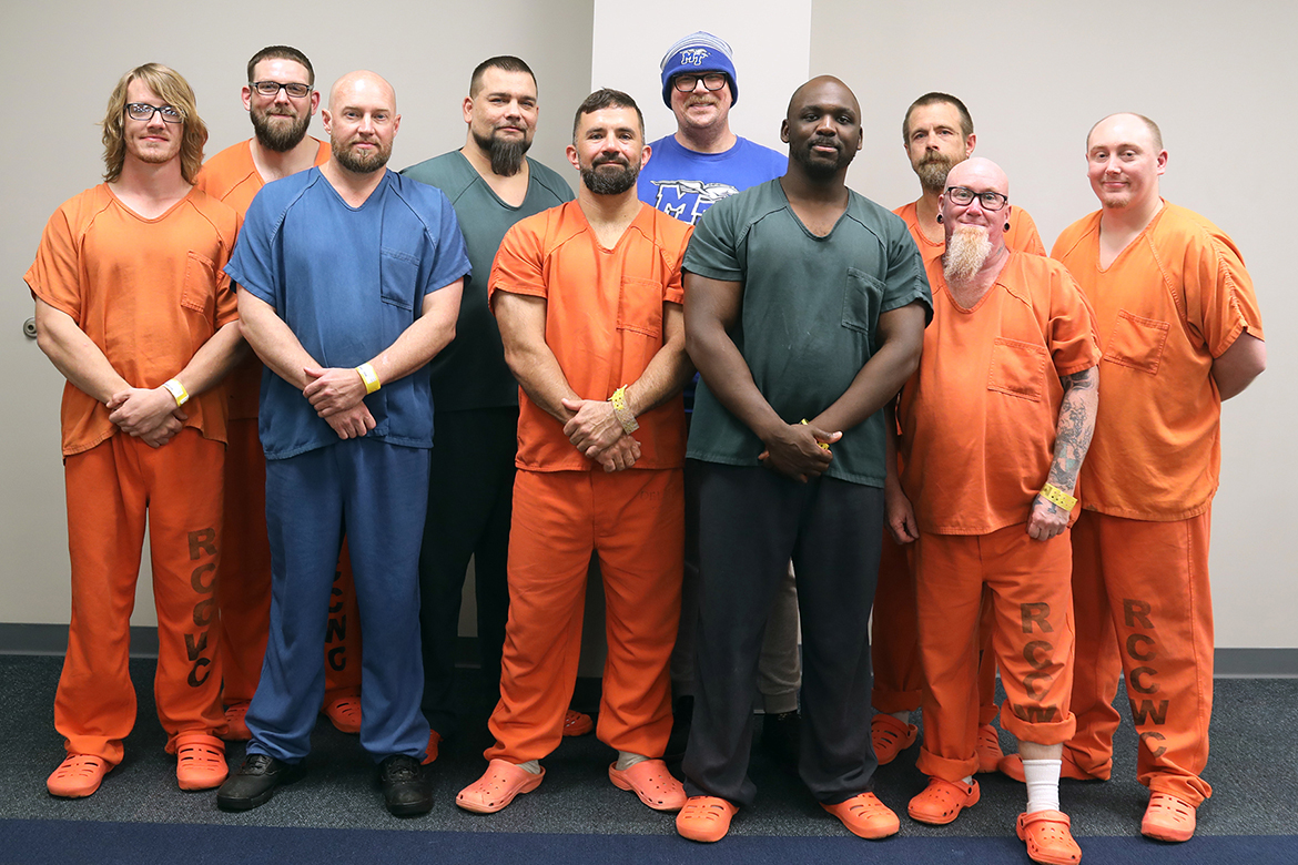 Middle Tennessee State University senior media arts major and Honors College student Brian Maxwell, back center in toboggan, is shown with Rutherford County Correctional Work Center inmates he trains in video and film production at the center in Murfreesboro, Tenn. Pictured, from left, are Devin Adamson, Michael Martin, Daniel Orndorff, Jeremy Lambert, Jeremy Travis, Brian Maxwell, Matthew Spann, James Harris, Jeremy Bell and David Hughes. (Photo by Robin E. Lee)