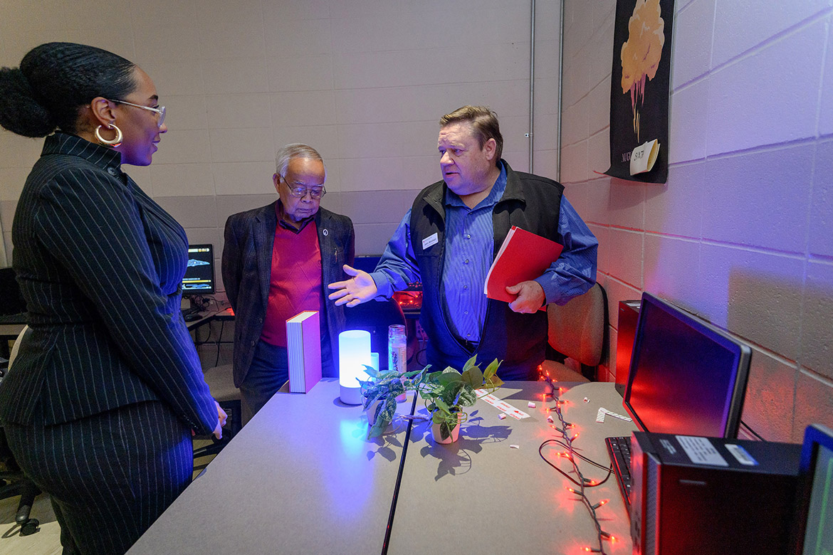 Political science major Alandra McMillan, left, talks to Rutherford County Commissioner Chantho Sourinho, middle, and American Red Cross Heart of Tennessee Chapter Executive Director John Mitchell during an escape room-style activity created by students in professor Amy Atchison’s Humanitarian Aid and Crisis class at Middle Tennessee State University on Nov. 28, 2023. (MTSU photo by J. Intintoli)