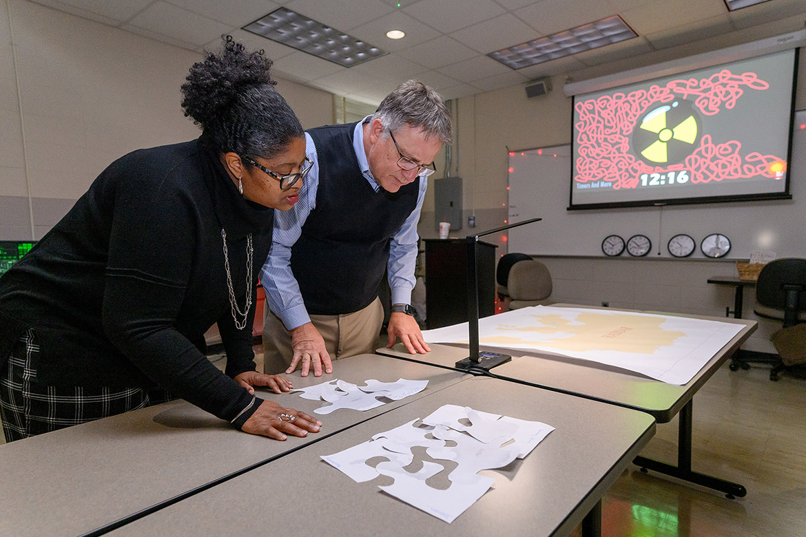 Middle Tennessee State University College of Liberal Arts Dean Leah Lyons, left, and University Provost Mark Byrnes work together to solve a puzzle for an escape room-style activity created by students in the Humanitarian Aid and Crisis class taught by Amy Atchison, chair of MTSU’s Political Science and International Relations Department. The duo solved a puzzle that prevented a nuclear explosion scenario. (MTSU photo by J. Intintoli)
