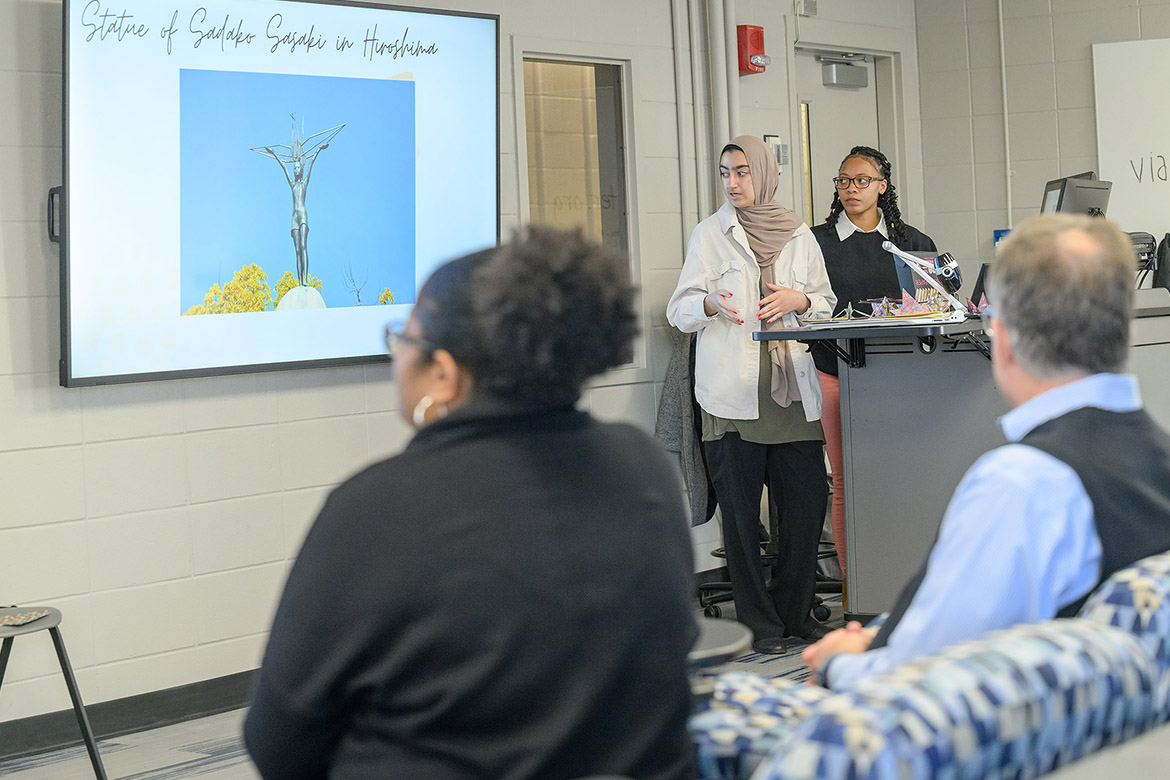 Students in Middle Tennessee State University professor Amy Atchison’s Humanitarian Aid and Crisis class, Zalykha Rasuli, left, and Sameria Bohanon explain the story of Sadako Sasaki, whose exposure to the atomic bomb dropped on Hiroshima, Japan, in 1945 caused cancer that ultimately took her life. On the front row, College of Liberal Arts Dean Leah Lyons, left, and University Provost Mark Byrnes listen. As part of coursework, students participated in the American Red Cross Youth Action Campaign to educate others about effects of nuclear war. (MTSU photo by J. Intintoli)