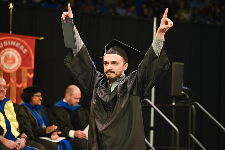 A member of Middle Tennessee State University’s Class of 2023 celebrates earning his diploma just after crossing the stage at Murphy Center during the morning fall commencement ceremonies. MTSU presented 1,761 undergrad and graduate degrees to students in two ceremonies held Dec. 16. (MTSU photo by Cat Curtis Murphy)
