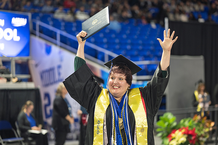 A member of Middle Tennessee State University’s Class of 2023 raises her hands in celebration after getting her diploma during the morning fall commencement ceremony. MTSU presented 1,761 undergrad and graduate degrees to students in two ceremonies held Dec. 16. (MTSU photo by Cat Curtis Murphy)
