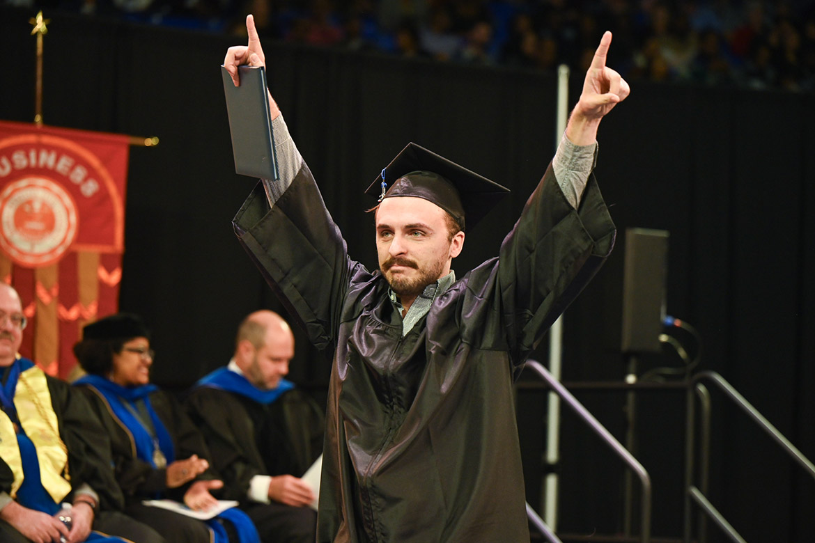 A member of Middle Tennessee State University’s Class of 2023 raises his hands in celebration after getting her diploma during the afternoon fall commencement ceremony. MTSU presented 1,761 undergrad and graduate degrees to students in two ceremonies held Dec. 16. (MTSU photo by Andy Heidt)