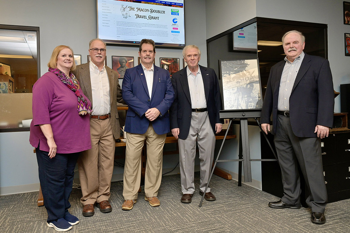 Family members of Uncle Dave Macon, the first Grand Ole Opry superstar, stand in the Center for Popular Music at Middle Tennessee State after their Macon-Doubler Fellowship nonprofit donated $5,000 to fund travel grants to research the life and legacy of their great-grandfather. Gathered at the center are, from left, Katie Doubler Steuart, John Doubler, Paul Doubler, Bernie Doubler and Mike Doubler. (MTSU photo by Andy Heidt)