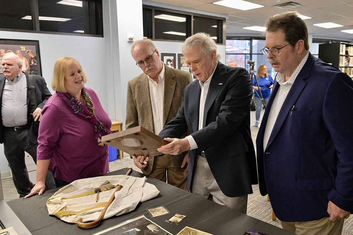 Great-grandchildren of the late music legend, Uncle Dave Macon, peruse memorabilia from holdings at the Center for Popular Music at Middle Tennessee State University, from left, Mike Doubler, Macon-Doubler Fellowship director; Katie Doubler Steuart, John Doubler, Bernie Doubler and Paul Doubler. The family was on hand Nov. 20, 2023, in the center to announce grand funding for scholars to visit the center and research the life and legacy of Uncle Dave Macon, regarded as the first Grand Ole Opry superstar. (MTSU photo by Andy Heidt)