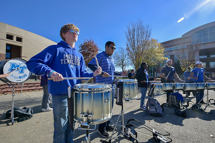 The drumline of Middle Tennessee State University’s Band of Blue warms up on the quad outside of the College of Media and Entertainment on Nov. 27, 2023, as part of the university’s collaborative project to produce a new recording of the MTSU fight song. (MTSU photo by Andy Heidt)