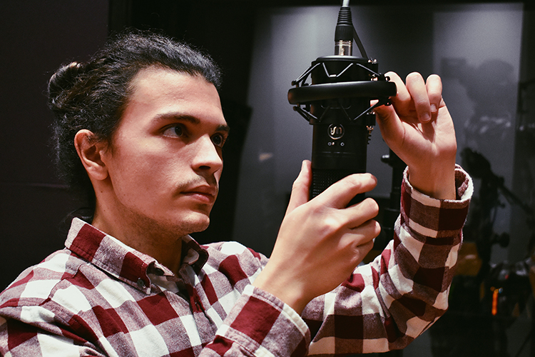 Kolyo Vanchev, Middle Tennessee State University graduate audio production student, sets up a mic for a production on campus. (Submitted video)