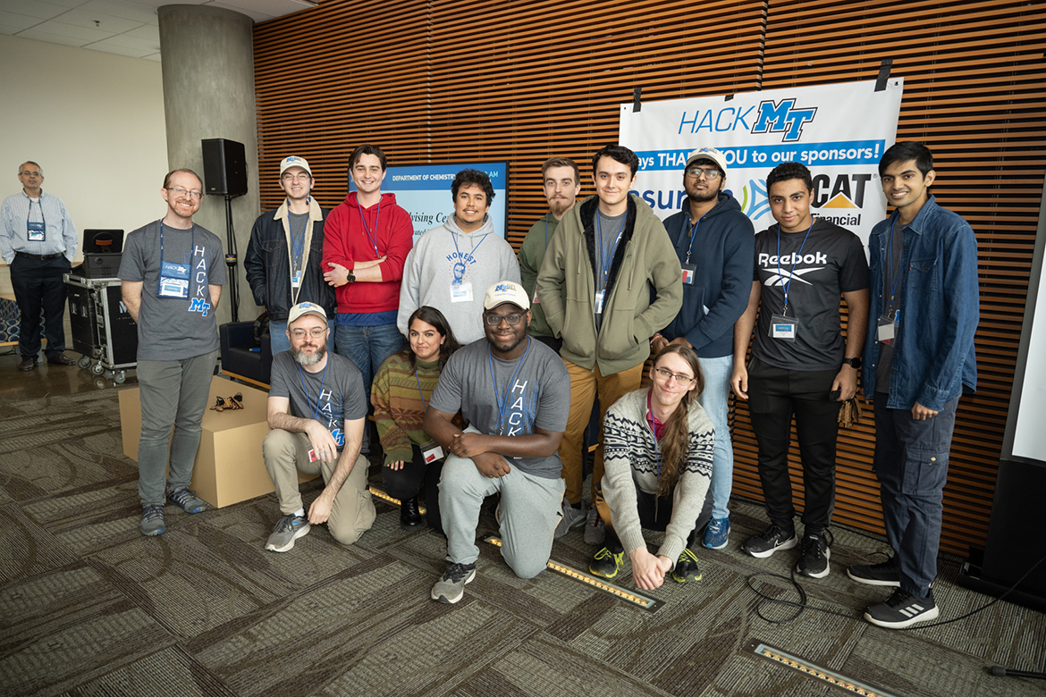 Team members from first-place winner BlueAid gather for a photo during the awards ceremony wrapping up the ninth annual Middle Tennessee State University Computer Science HackMT in the Science Building Sunday, Jan. 28. They created technology to help consumers spot overcharges in their hospital bill. (MTSU photo by James Cessna)