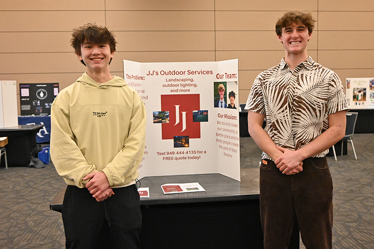High school juniors John Lee, left, and Jacob Dykstra of Franklin High School stand with their display for JJ’s Outdoor Services during MTSU’s 2024 High School Entrepreneurship Fair held Tuesday, Feb. 20, in the Student Union Ballroom. The students were among the top five finalists. (MTSU photo by Johari Hamilton)