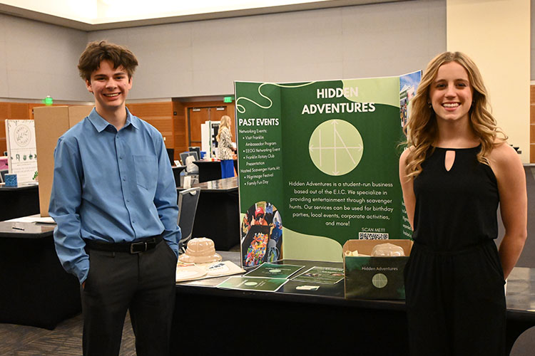 High school juniors Eli Lami of Centennial High School, left, and Anna Riley of Brentwood High School stand with their display for their business called Hidden Adventures during MTSU’s 2024 High School Entrepreneurship Fair held Tuesday, Feb. 20, in the Student Union Ballroom. The students were among the top five finalists. (MTSU photo by Johari Hamilton)