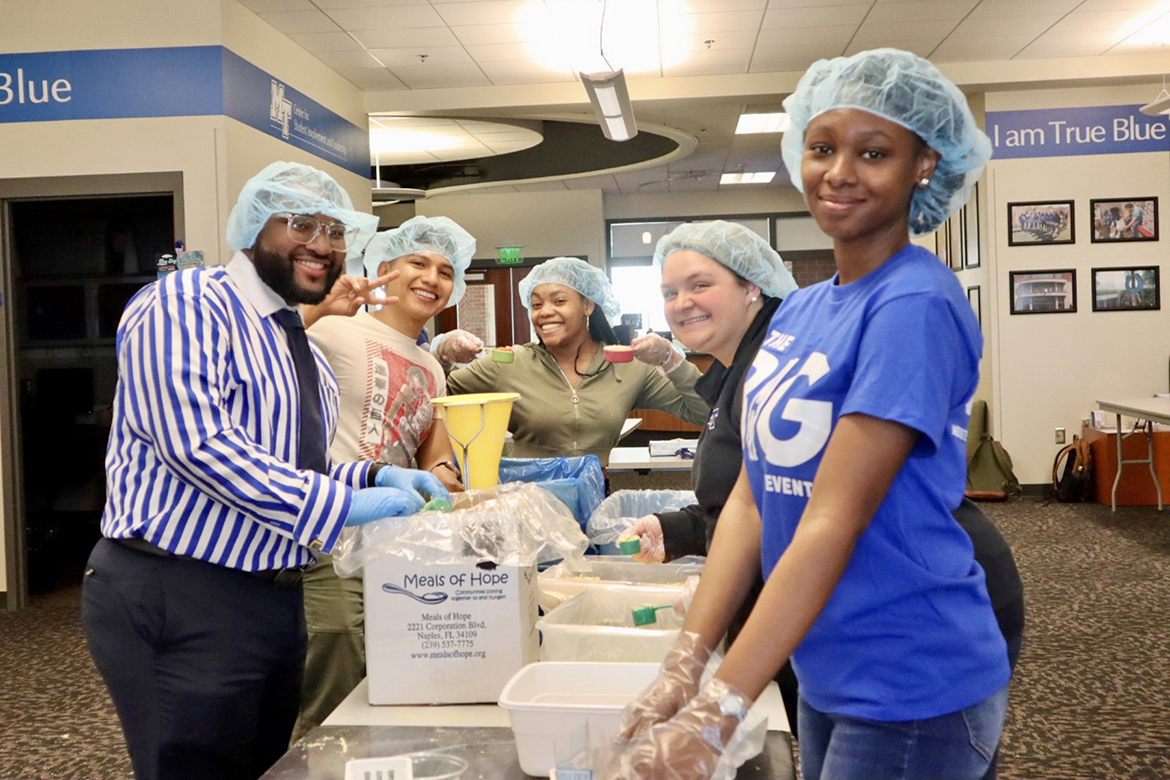 Middle Tennessee State University student Michai Mosby, left, president of the Student Government Association, joins other student volunteers Wednesday, Feb. 21, in the Student Union in helping package 15,000 meals filled with a variety of nonperishable items as part of the university’s annual Big Event community service project. Organizers said most of the meals will be donated to the MTSU Food Pantry and the remainder will be donated to Nourish Food Bank. More than 80 students participated. (MTSU photo courtesy of Jackie Victory)