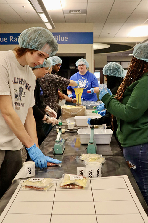 A group from the more than 80 Middle Tennessee State University student volunteers assist in packing 15,000 meals filled with a variety of nonperishable items as part of the university’s annual Big Event community service project held Wednesday, Feb. 21, in the Student Union Building. Organizers said most of the meals will be donated to the MTSU Food Pantry and the remainder will be donated to Nourish Food Bank. (MTSU photo courtesy of Jackie Victory)
