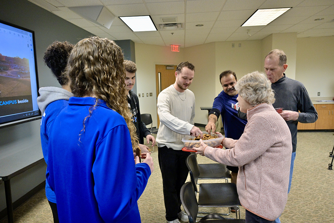 Carol Detmer offers home-baked cookies to MTSU Campus Recreation Center student workers who helped save the life of her husband, Richard Detmer, second from right, during their visit to a second-floor conference room at Middle Tennessee State University’s Health, Wellness and Recreation Center Friday, Feb. 9. From left are Julia Rutledge, Jasmine Jackson, Andrew Scrugham, Gatlin Murr and Jones College of Business marketing professor Raj Srivastava, who was playing racquetball when Detmer had cardiac arrest Jan. 19. Detmer is a retired professor and Computer Science Department chair. (MTSU photo by Andy Heidt)