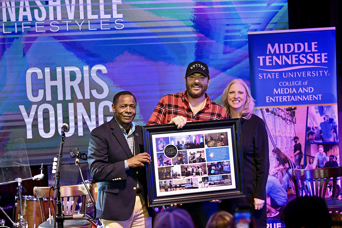 Middle Tennessee State University President Sidney A. McPhee, left, and Beverly Keel, dean of the College of Media and Entertainment, right, present country music superstar and alumnus Chris Young with a framed photo montage of students using the campus’ Chris Young Café during a special concert Feb. 7 at Blake Shelton’s Ole Red restaurant and live music venue in downtown Nashville, Tenn. (MTSU photo by James Cessna)
