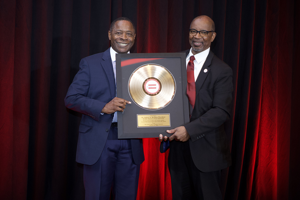 Middle Tennessee State University President Sidney A. McPhee, left, receives a framed thank you gift from Urban League of Middle Tennessee President and CEO Clifton E. Harris after giving keynote remarks at the civil rights organization’s 56th “Equal Opportunity Day” luncheon held Feb. 22 at the Music City Center in Nashville, Tenn. (Photo by Emanuel O. Roland II)