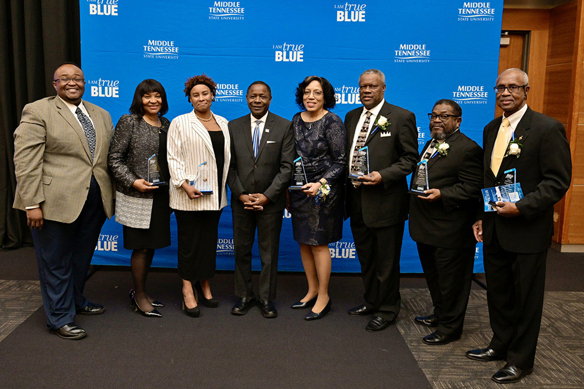 Middle Tennessee State University President Sidney A. McPhee, fourth from left, joined the university in honoring six “unsung heroes” during the 28th annual Unity Luncheon held Thursday, Feb. 8, at the Student Union Building. Pictured, from left, are Gerald Patton, former student of posthumous honoree Johnie Payton (contribution to Black arts); Patricia Waire Harlan (advocate of civility); Bryanna Payton, niece of posthumous honoree Payton; McPhee; Sharonese Henderson (community service); and Edd Hill, Collier Woods and Stanley Murphy (education). (MTSU photo by Andy Heidt)
