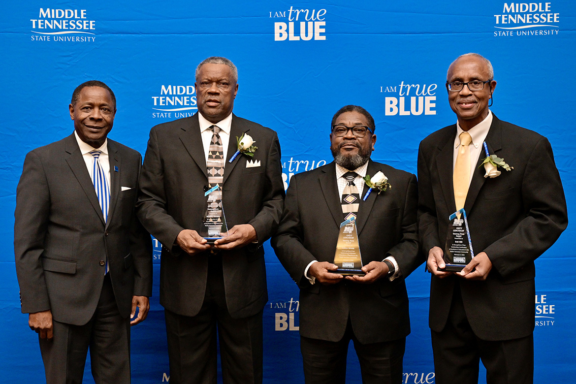 Middle Tennessee State University President Sidney A. McPhee, left or right, presents "unsung hero" Award for Education to Kool Club Scholarship co-founders, second from left, Edd Hill, Collier Woods and Stanley Murphy at the 2024 Unity Luncheon held Thursday, Feb. 8, in the Student Union Ballroom. (MTSU photo by Andy Heidt)