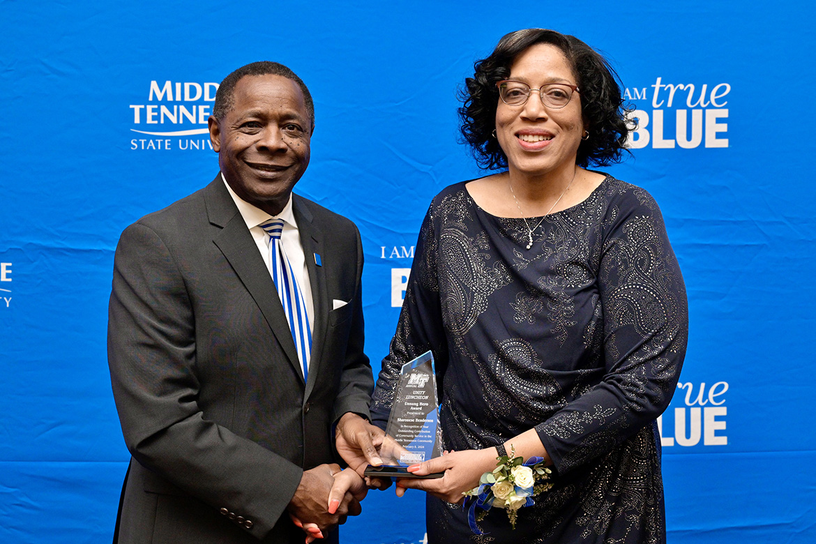Middle Tennessee State University President Sidney A. McPhee, left, presents "unsung hero" Award for Community Service to Sharonese Henderson at the 2024 Unity Luncheon held Thursday, Feb. 8, in the Student Union Ballroom. (MTSU photo by Andy Heidt)