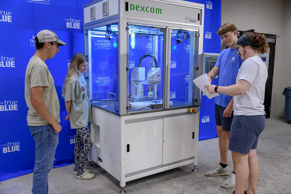 Middle Tennessee State University students Jason Huffman, left, of Powder Springs, Ga., Lily Hardin of Nashville, Tenn., Daniel Wetter of Murfreesboro, Tenn., and Jackson Clemons of Knoxville, Tenn., inspect the new robotics equipment given to the Engineering Technology Department by Dexcom during the fall 2023 semester. Fellow partner Automation Nth joined in with an additional commitment in the former of equipment and services to upgrade the units. (MTSU photo by J. Intintoli)