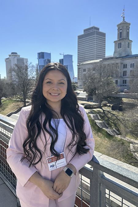 Rose Gutierrez, a Middle Tennessee State University undergraduate student and researcher, poses for a photo of the Cordell Hull Building in between sharing her research into minimizing radiation side effects in cancer treatment at the annual Posters at the Capitol event held Feb. 14, 2024, at the state Capitol in Nashville, Tenn. (Submitted photo)