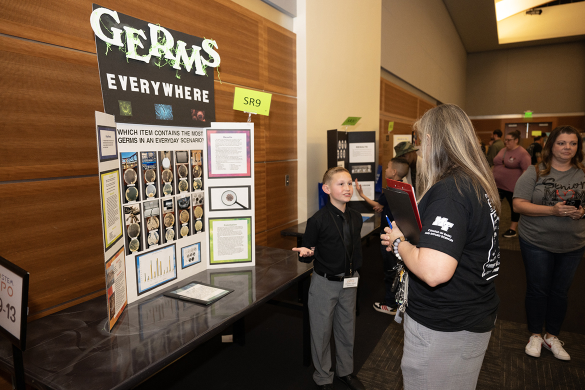 Colton Hartley, left, a fifth grader at Brown’s Chapel Elementary School in Murfreesboro, Tenn., discusses his “Germs Everywhere” research to a judge during the recent Rutherford County STEM Expo, held in Middle Tennessee State University’s Student Union Ballroom. Hartley’s research received a special award from the MTSU College of Basic and Applied Sciences. (MTSU photo by James Cessna)