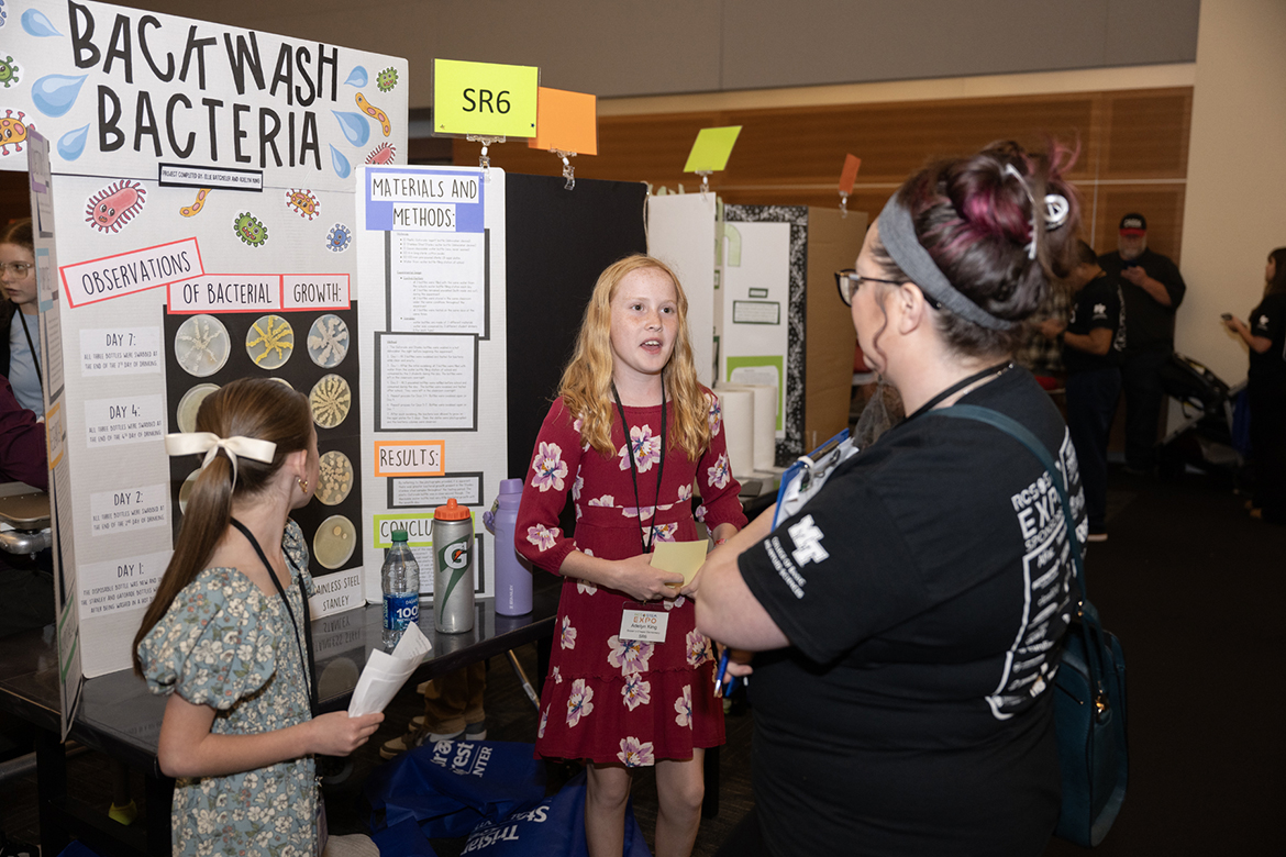 As fellow Brown’s Chapel Elementary fifth grade research collaborator Ellie Batcheler, left, listens, Adelyn King discusses their “Backwash Bacteria” project with a judge during the recent Rutherford County Schools’ STEM Fair in the Middle Tennessee State University Student Union Ballroom in Murfreesboro, Tenn. Brown’s Chapel was among 19 county schools participating in the sixth annual event. (MTSU photo by James Cessna)
