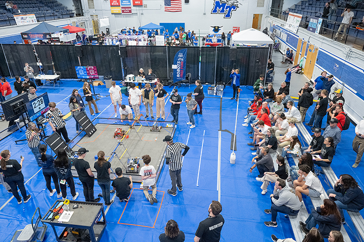 As spectators, judges and other event officials observe, competitors square off with their robots in the pit areas in Middle Tennessee State University’s Alumni Memorial Gym Saturday, March 2, in the TNFIRST First Tech Challenge Tennessee State Championship. The event was hosted by the MTSU Engineering Technology Department. (MTSU photo by Cat Curtis Murphy)