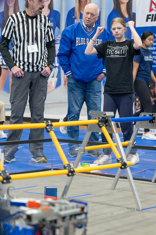 Ken Currie, center, chair of the Middle Tennessee State University Engineering Technology Department, watches the TNFIRST First Tech Challenge Tennessee State Championship, held in Alumni Memorial Gym Saturday, March 2. The department sponsored the event along with Schneider Electric. He later awarded two scholarships to high school juniors. (MTSU photo by Cat Curtis Murphy)