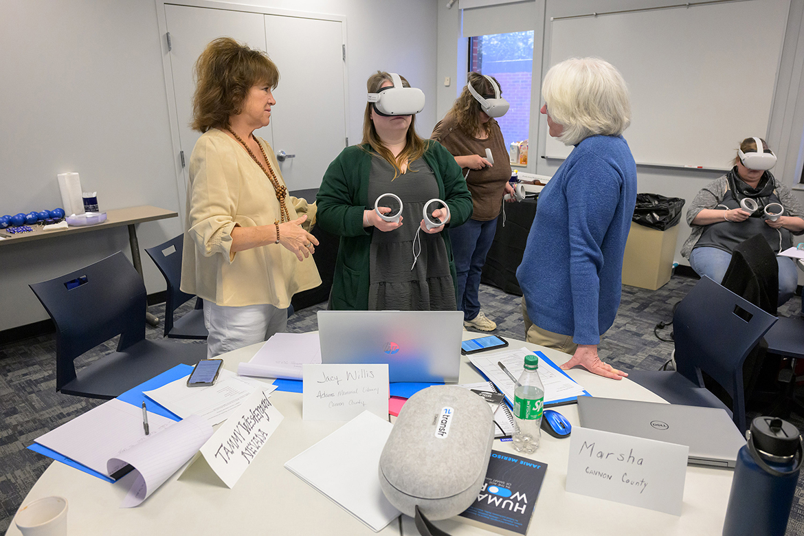 Tammy Westergard, left, Nevada Governor’s Office of Economic Development’s senior workforce development librarian-in-residence, assists Jacy Willis and Marsha Petty, both from the Adams Memorial Library in Woodbury, Tenn., with Transfr virtual reality training recently in a Middle Tennessee State University Fairview Building classroom in Murfreesboro, Tenn. Librarians from six rural Midstate counties attended the training that will enable their patrons to use the Transfr VR technology to pursue career opportunities. MTSU researchers are conducting applied research to investigate VR career exploration and training initiatives in libraries and their role in yielding positive workforce outcomes for patrons. (MTSU photo by Andy Heidt)