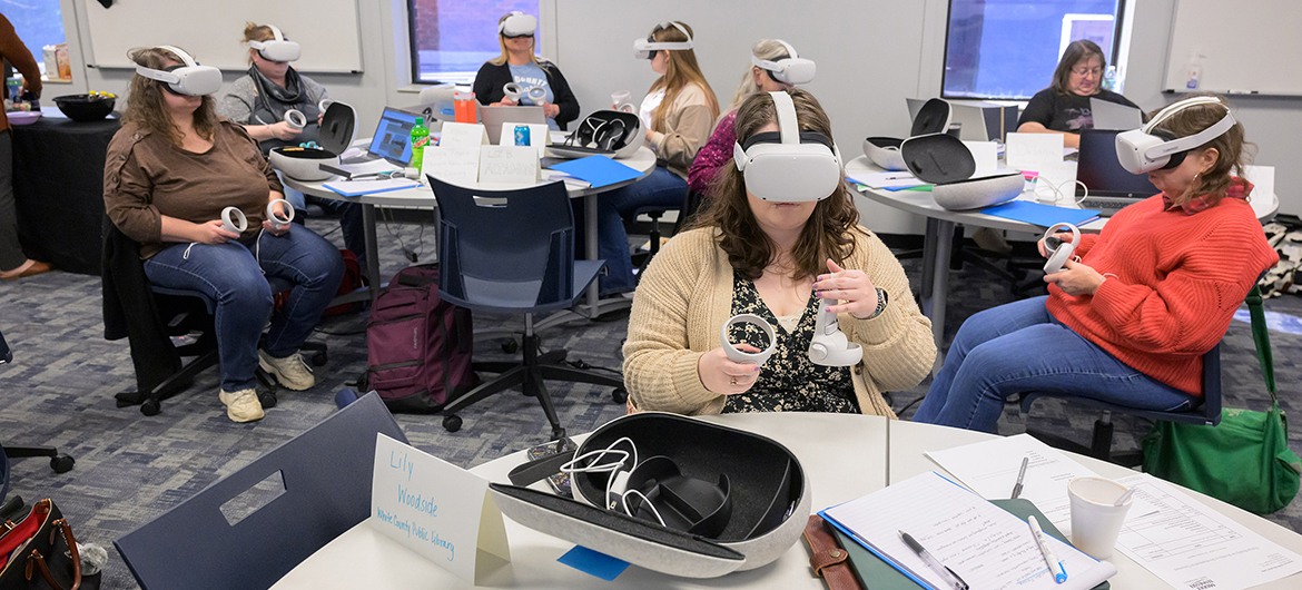 Participants including Lily Woodside, center, from the White County Public Library in Sparta, Tenn., go through virtual reality training provided by Transfr recently in a Middle Tennessee State University Fairview Building classroom in Murfreesboro, Tenn. The training will help the librarians from six rural counties assist their patrons in pursuing job opportunities with the same VR technology. A federal grant from the Institute of Museum and Library Services obtained by MTSU’s School of Agriculture is aiding in the effort. (MTSU photo by Andy Heidt)