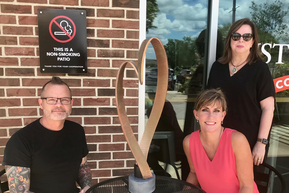 MTSU art associate professor Michael Baggarly, left, shares a model of his commissioned sculpture with Rutherford Arts Alliance artists Ginny Togrye, seated right, and Sharon Kolli. (Photo submitted)