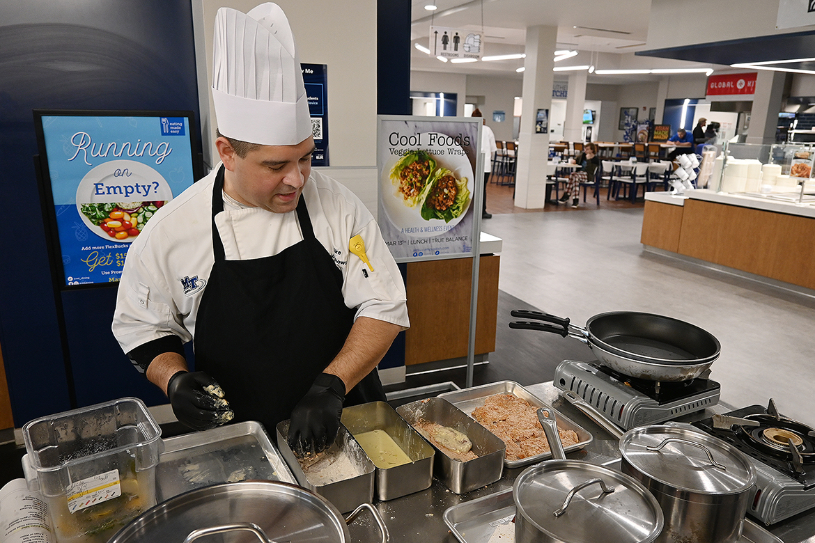Aramark Collegiate Hospitality Services Chef Mike Wojciechowski, who oversees operations at McCallie Dining Hall and Farmers Market Dining Hall on the campus of Middle Tennessee State University in Murfreesboro, Tenn., practices cooking in front of a crowd during lunchtime rush in early March at McCallie inside Keathley University Center in preparation for the Aramark Culinary Excellence Competition held earlier in the spring. (MTSU photo by Nancy DeGennaro)