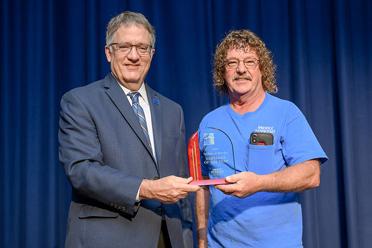 Middle Tennessee State University Provost Mark Byrnes presents the 2023-24 Technical/Service Employee of the Year Award to Forrest Higginbotham from Building Services at a reception held at James Union Building on campus in Murfreesboro, Tenn. He was one of four employees to receive an award. (MTSU photo by Andy Heidt)