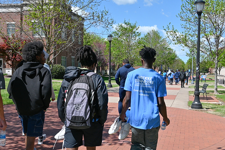 Middle Tennessee State University students and students from Oakland Middle School in Murfreesboro, Tenn., walk across campus to grab lunch on a sunny April 12, 2024, during the middle schoolers’ field trip to MTSU as part of the Emerging Leaders Academy mentorship program put on by the College of Education’s Center for Fairness, Justice and Equity. (MTSU photo by Stephanie Wagner)