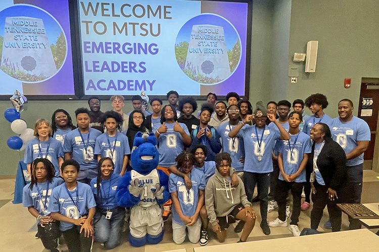 Middle Tennessee State University students and students from Oakland Middle School, located in in Murfreesboro, Tenn., pose for a photo with MTSU mascot Lightning, kneeling front and center, at the College of Education Building on April 12, 2024. The middle schoolers — sporting their new completion medals around their necks — came to campus as part of the larger Emerging Leaders Academy, a mentorship program for local middle schoolers put on by the college’s Center for Fairness, Justice and Equity. (Submitted photo)