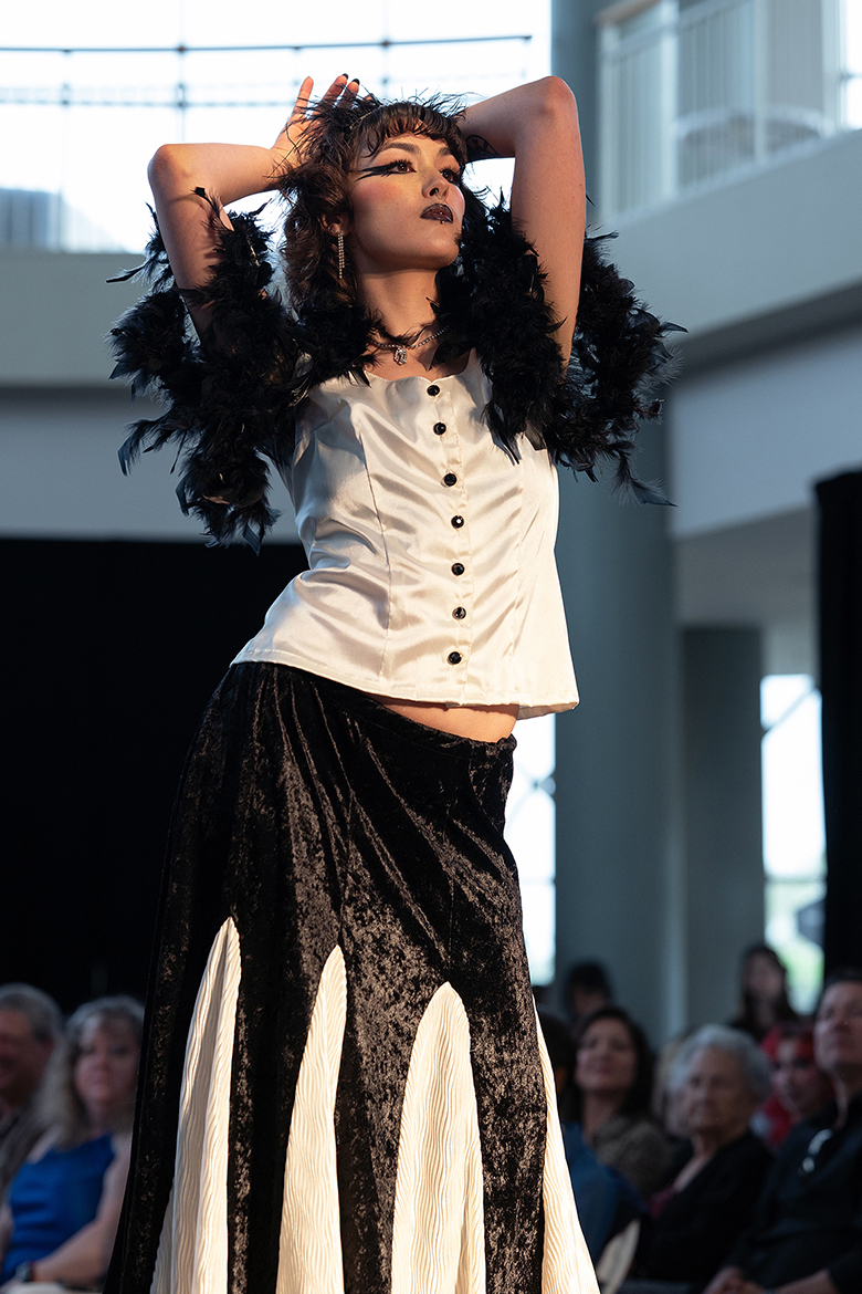 Model Amber Harvey pauses at the end of the runway to show off her outfit at Middle Tennessee State University's 2024 Textiles, Merchandising and Design Runway Show held Saturday, April 20, at Miller Education Center in Murfreesboro, Tenn. (MTSU photo by Cat Curtis Murphy)