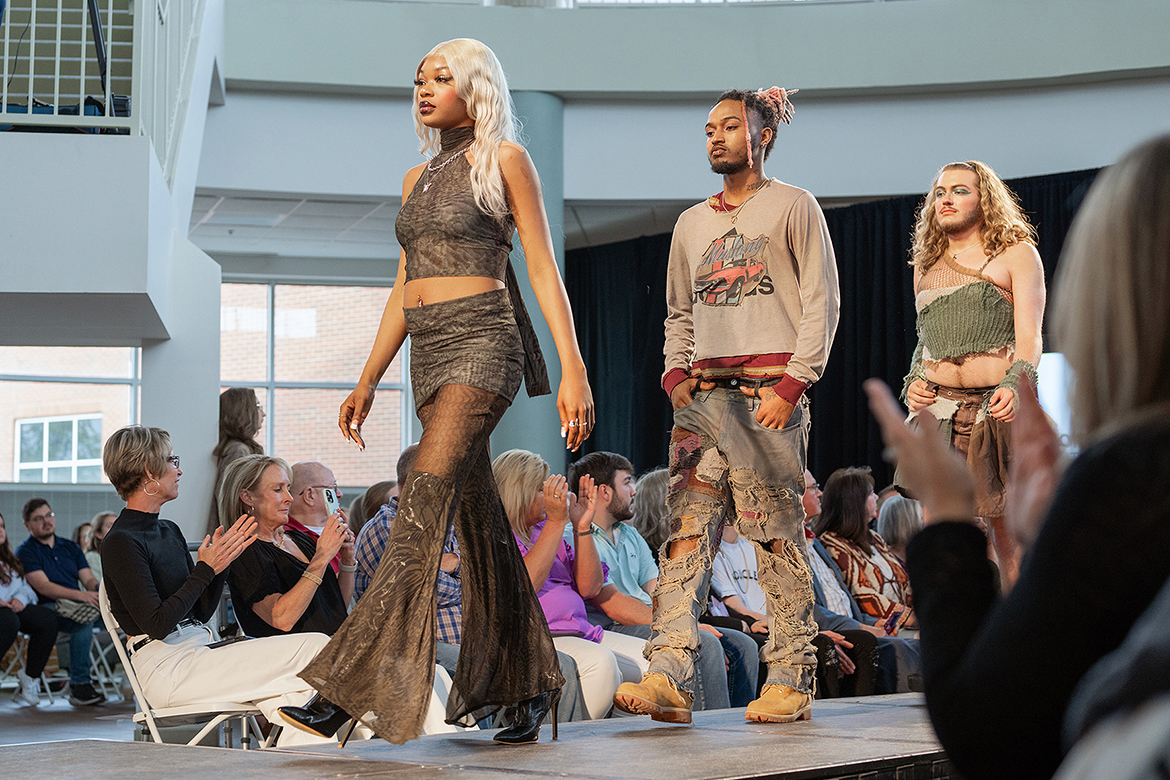 From left, models Jermaiya Grimes, Ladarian Lee and Logan Owens show off a clothing collection at Middle Tennessee State University's 2024 Textiles, Merchandising and Design Runway Show held Saturday, April 20, at Miller Education Center in Murfreesboro, Tenn. (MTSU photo by Cat Curtis Murphy)