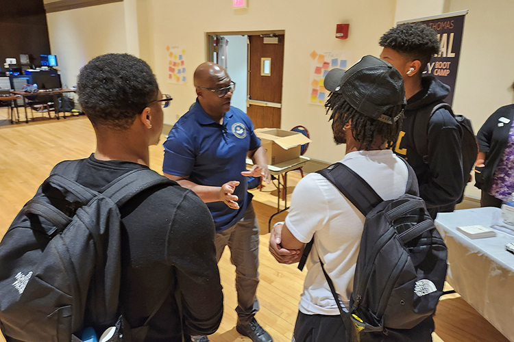 U.S. Army veteran and author Michael “Bootcamp” Thomas, center left, chats with students, from left, Tyree Brown, Terrance Taylor and Jaylen Few following his keynote address for Middle Tennessee State University’s Financial Literacy Month on April 10 in the Tennessee Room of the James Union Building on the MTSU campus in Murfreesboro, Tenn. MTSU’s Department of Economic and Finance has hosted financial literacy events throughout the month. (MTSU photo by Jimmy Hart)