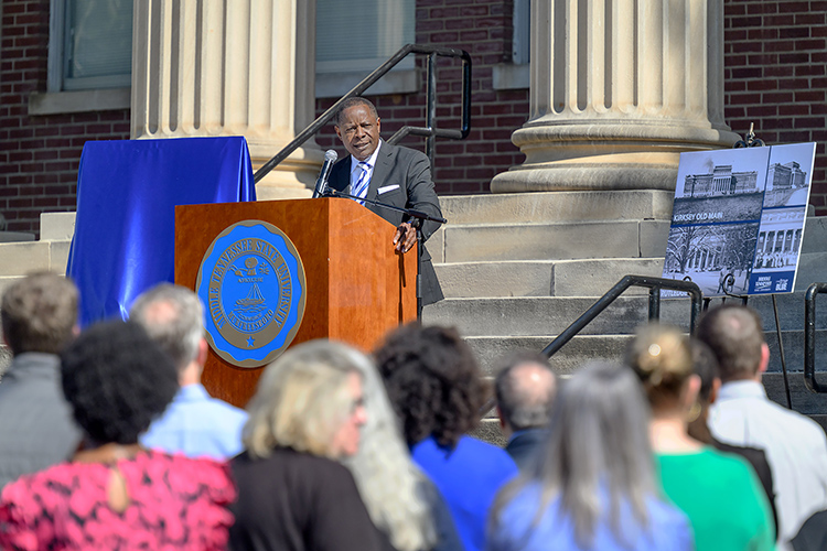 Speaking Wednesday, April 24, from the steps of Kirksey Old Main on the Middle Tennessee State University campus in Murfreesboro, Tenn., MTSU President Sidney A. McPhee provides details about the $54.3 million renovation project to upgrade Kirksey and Rutledge Hall that begins in mid-May with an expected completion by summer 2026. At right are historic images of the buildings, two of the five original buildings on the campus. (MTSU photo by J. Intintoli)