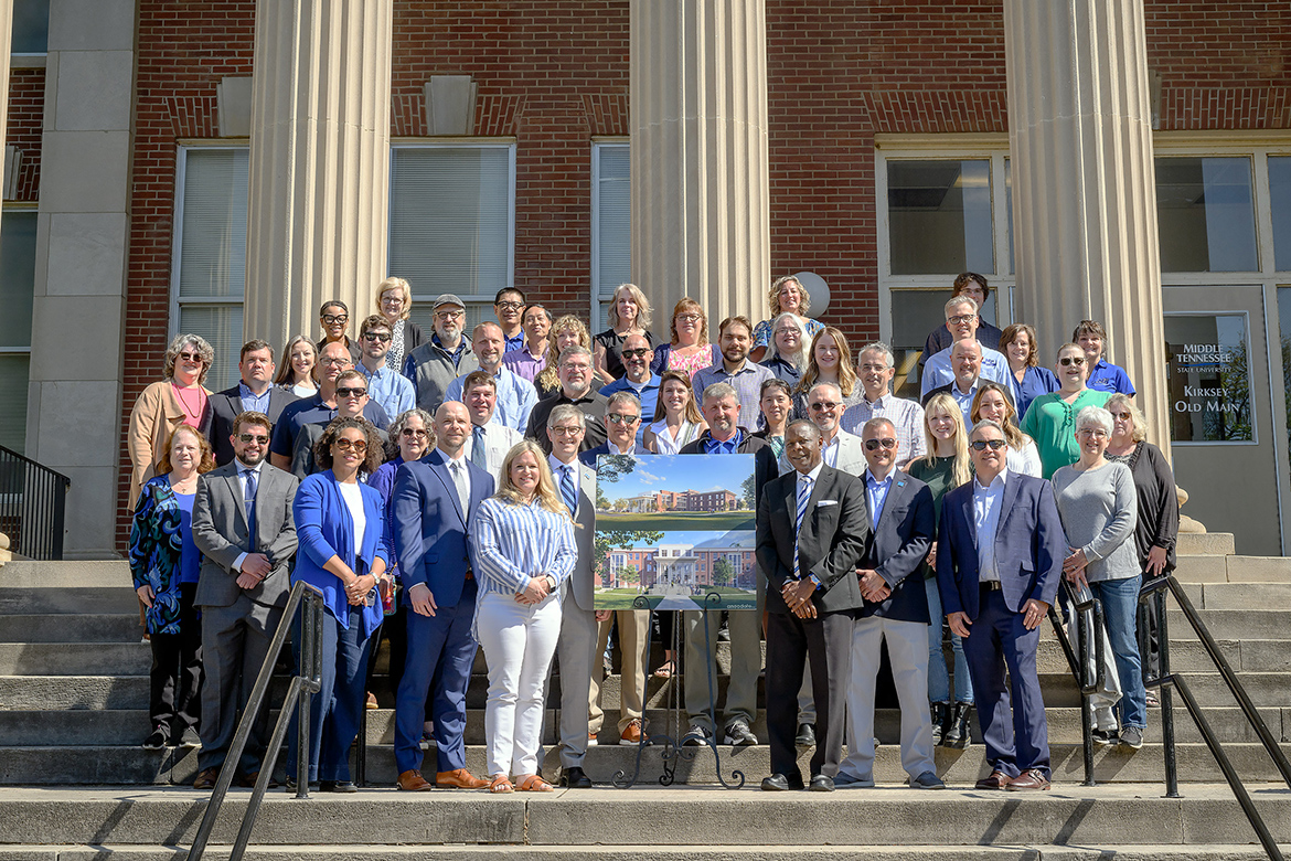 Middle Tennessee State University President Sidney A. McPhee, center right next to rendering, is joined Wednesday, April 24, by other university leaders and faculty and staff from the Mathematics, Computer Science, and Data Science departments within the College of Basic and Applied Sciences, the University Studies Department, and the Campus Planning Department on the steps of Kirksey Old Main following the announcement of a $54.3 million renovation project to upgrade Kirksey and Rutledge Hall, two of the campus’ five original buildings. (MTSU photo by J. Intintoli)