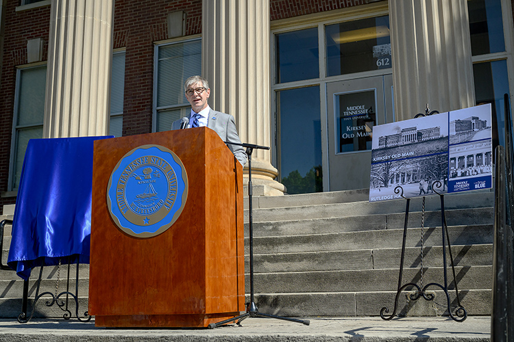 Speaking Wednesday, April 24, from the steps of Kirksey Old Main on the Middle Tennessee State University campus in Murfreesboro, Tenn., College of Basic and Applied Sciences Dean Greg Van Patten discusses the positive impact of the $54.3 million renovation project to upgrade Kirksey will have on the multiple CBAS departments housed there. The project, which also includes transforming nearby Rutledge Hall from a dormitory to an academic building, begins in mid-May with an expected completion by summer 2026. At right are historic images of the buildings, two of the five original buildings on the campus. (MTSU photo by J. Intintoli)