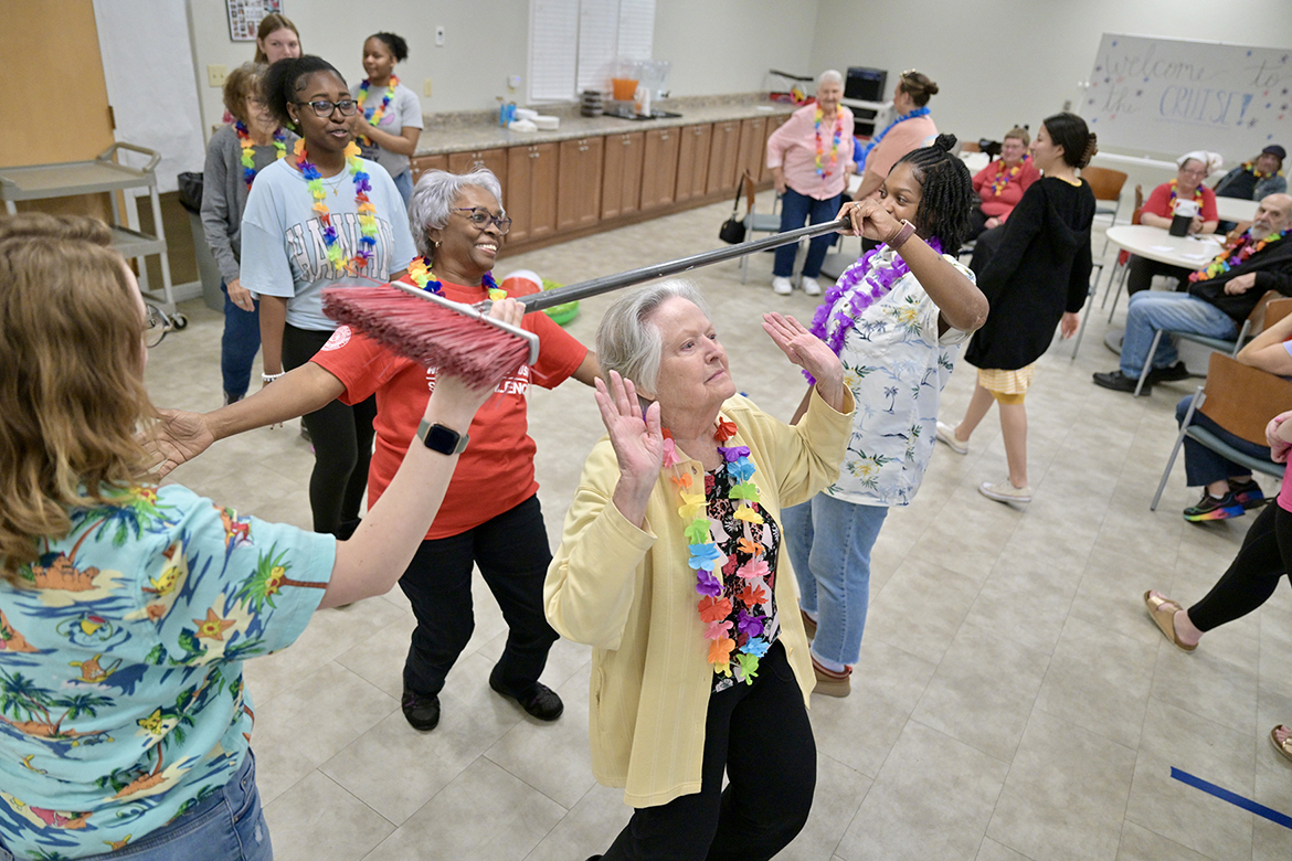 Students in the Aging Health and Development course at Middle Tennessee State University taught by Human Development and Family Science lecturer Samantha Weir, do the “limbo” with members of St. Clair Street Senior Center in Murfreesboro, Tenn., during a “cruise” party held as part of class on March 29, 2024. Each Friday during the semester, students plan and implement interactive games at St. Clair as well as Stones River Manor, also in Murfreesboro. (MTSU photo by J. Intintoli)