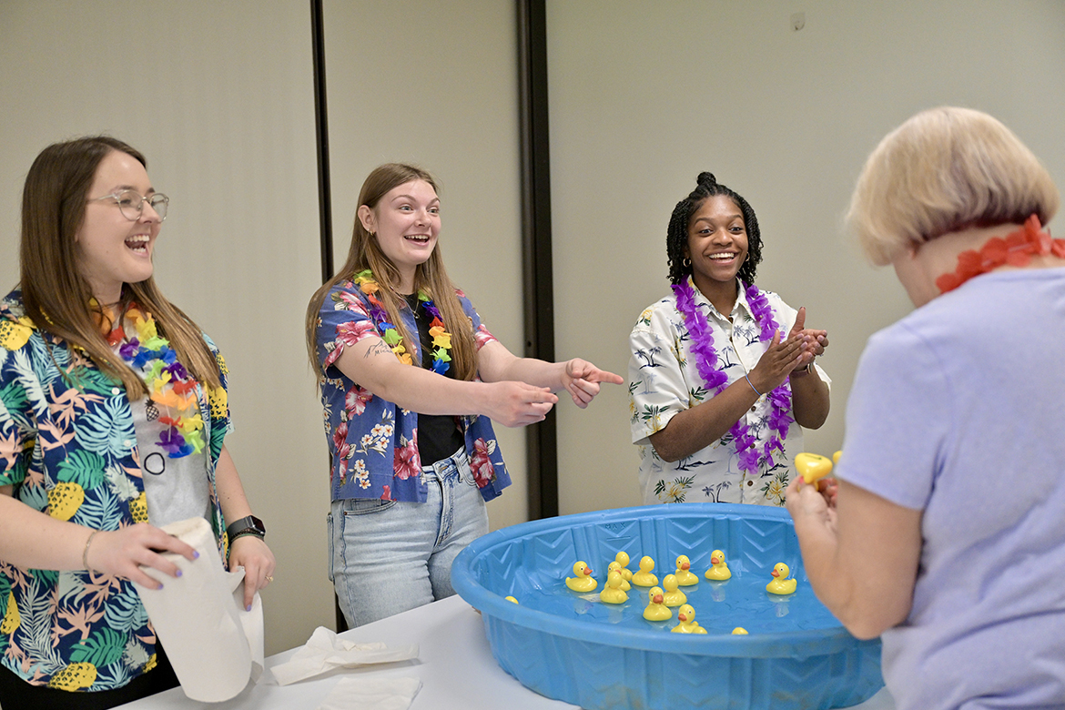 Middle Tennessee State University Aging Health and Development students, from left, Kylie Calvert, Katy Champion and Sydnee Washington lead a “match-the-duck” game at St. Clair Street Senior Center in Murfreesboro, Tenn., during a “cruise” party held as part of class on March 29, 2024. Each Friday during the semester, students in Human Development and Family Science lecturer Samantha Weir’s class plan and implement interactive games at St. Clair as well as Stones River Manor, also in Murfreesboro, where MTSU is located. (MTSU photo by J. Intintoli)