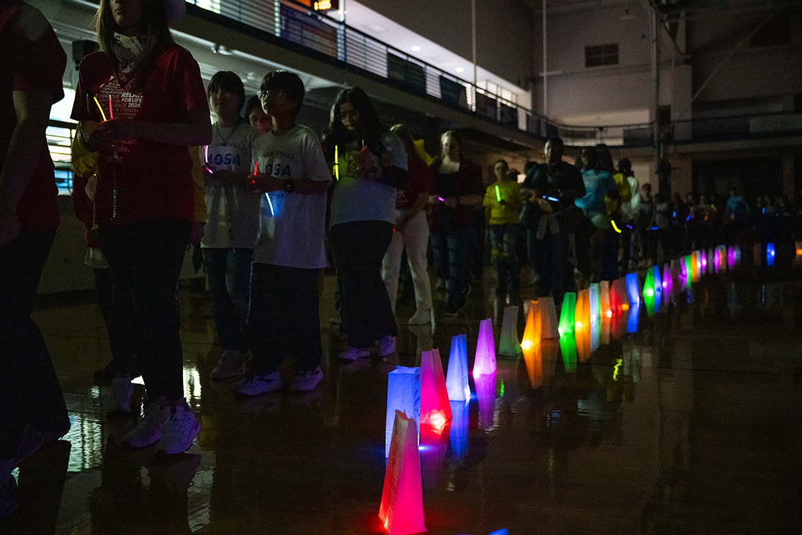 As part of the American Cancer Society MTSU Relay for Life event, participants parade around the Middle Tennessee State University Campus Recreation Center gym carrying LED glow sticks during the special luminaria ceremony. Many MTSU students turned out for the event, held March 22 on the MTSU campus in Murfreesboro, Tenn. (MTSU photo by Cat Curtis Murphy)