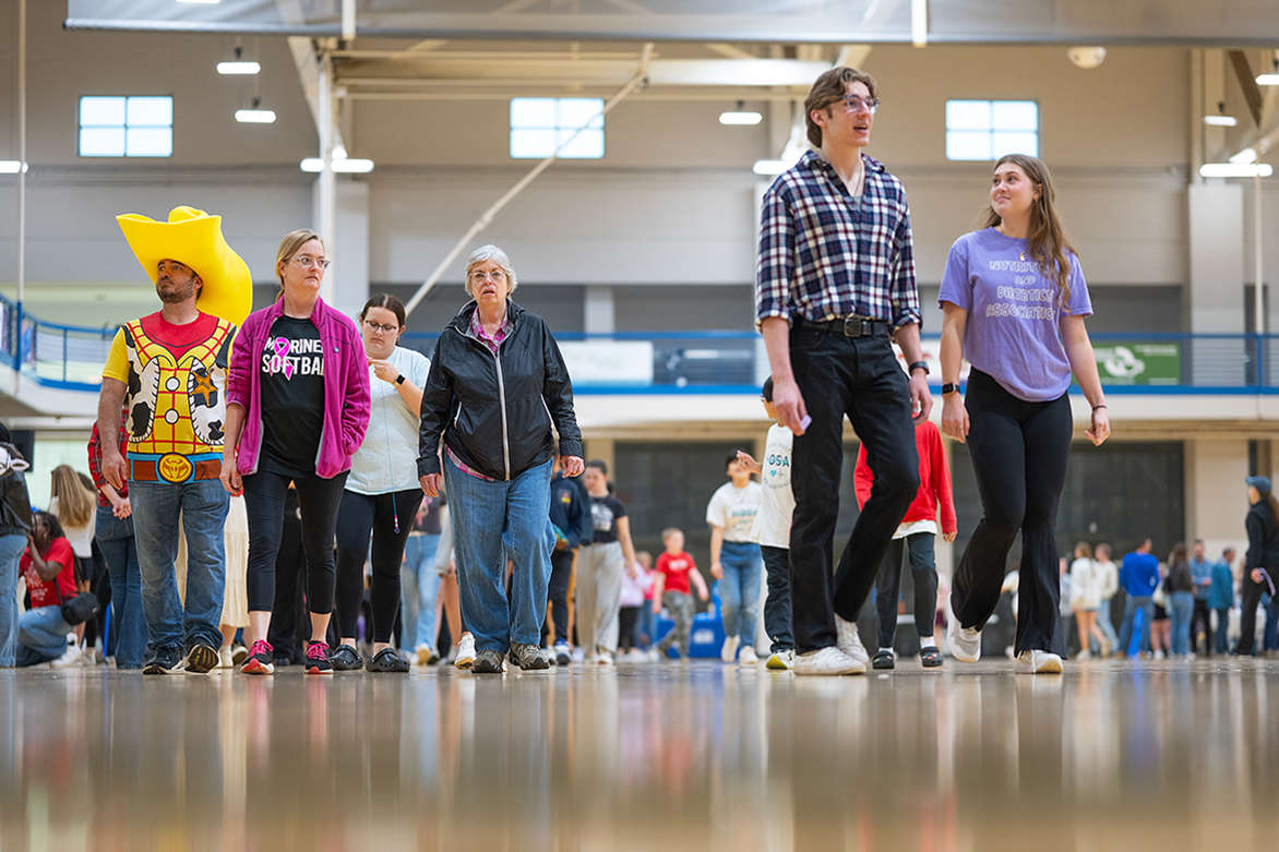 Participants walk around the Middle Tennessee State University Campus Recreation gym floor as part of the annual MTSU Relay for Life activities spread across four hours on the university campus in Murfreesboro, Tenn., on March 22. More than $16,300 has been raised by the student-led organization to help the American Cancer Society’s efforts to cure cancer. (MTSU photo by Cat Curtis Murphy)