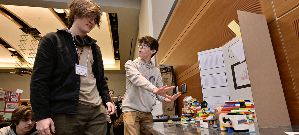 Hendersonville High School classmates Fern Smith, left, and Cole Robinson discuss Robinson’s engineering projects using Legos and a lathe Wednesday, April 3, during the annual Middle Tennessee STEM Innovation Hub STEM Expo, held in the Middle Tennessee State University Student Union Ballroom on the MTSU campus in Murfreesboro, Tenn. Robinson, a junior from Hendersonville, Tenn., said he is strongly considering MTSU as his college choice to study engineering and play viola in the orchestra. (MTSU photo by Andy Heidt)