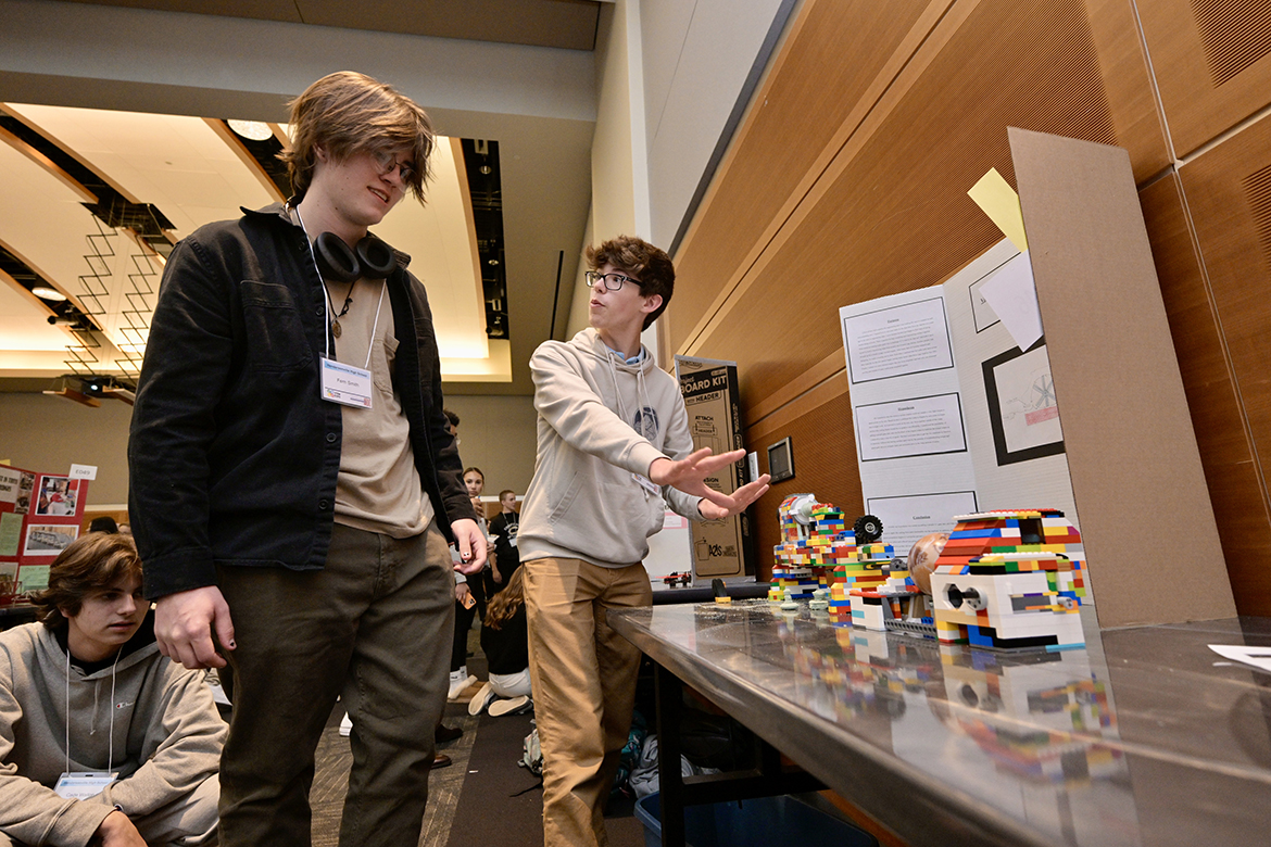 Hendersonville High School classmates Fern Smith, left, and Cole Robinson discuss Robinson’s engineering projects using Legos and a lathe Wednesday, April 3, during the annual Middle Tennessee STEM Innovation Hub STEM Expo, held in the Student Union Ballroom on the Middle Tennessee State University Student campus in Murfreesboro, Tenn. Robinson, a junior from Hendersonville, Tenn., said he is  strongly considering MTSU as his college choice to study engineering and play viola in the orchestra. (MTSU photo by Andy Heidt)