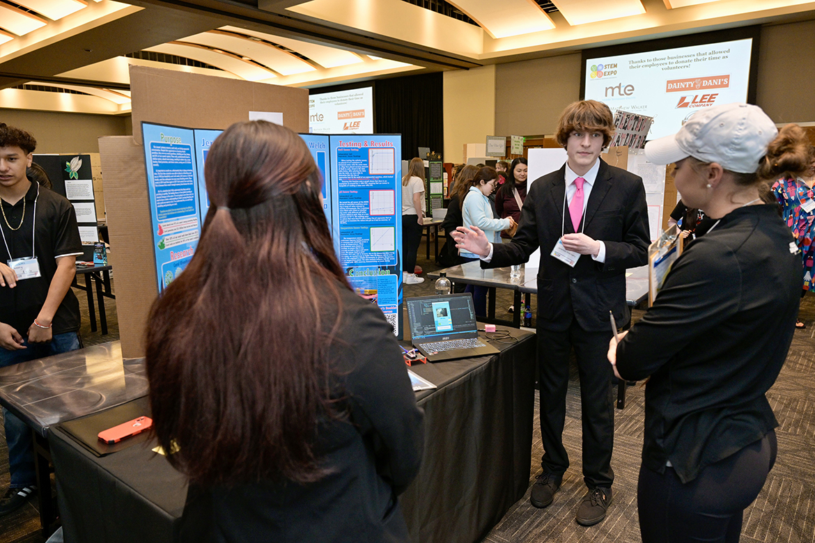 Jeremiah Abernathy, center, a student at Stewarts Creek Middle School in Smyrna, Tenn., answers a judge’s questions about his research project Wednesday, April 3, during the 12th annual Middle Tennessee STEM Innovation Hub STEM Expo in the Student Union Ballroom on the Middle Tennessee State University campus in Murfreesboro, Tenn. (MTSU photo by Andy Heidt)